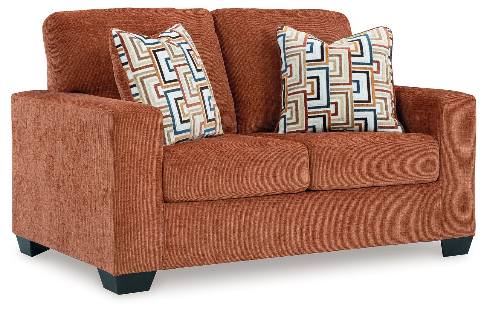 Brown loveseat with two geometric patterned throw pillows and squared arms