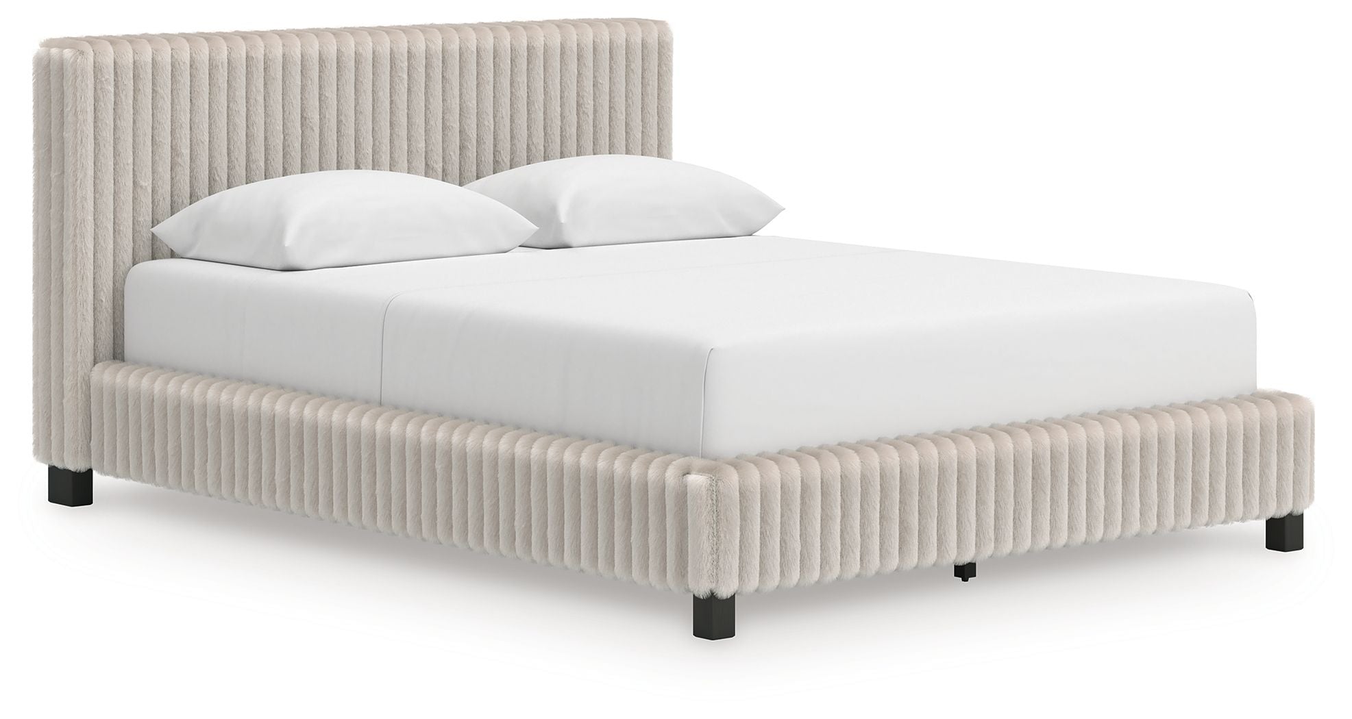 Upholstered bed with beige ribbed headboard and sides, white mattress and pillows