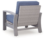 Blue lounge chair with gray frame and woven back panel, cushioned seat and armrests