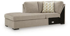 Stone gray left-arm corner chaise with seat cushions, patterned throw pillow, black legs