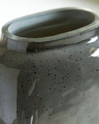 Close-up of vase rim and interior, dark speckled ceramic finish