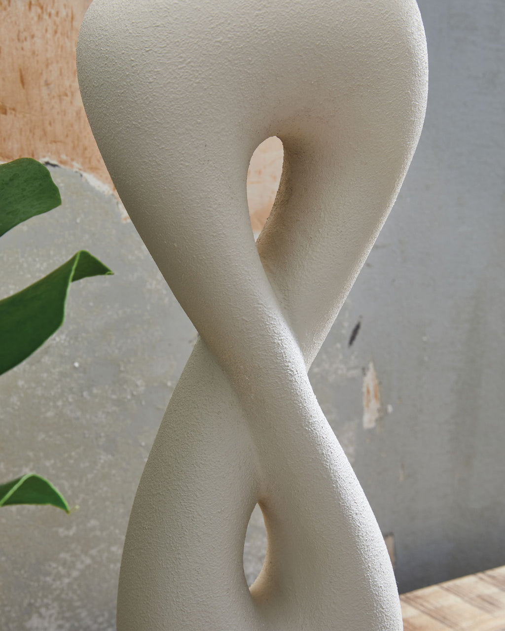 Sculpted white poly table lamp base with cutout hourglass shape and gold base ring
