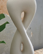 Sculpted white poly table lamp base with cutout hourglass shape and gold base ring
