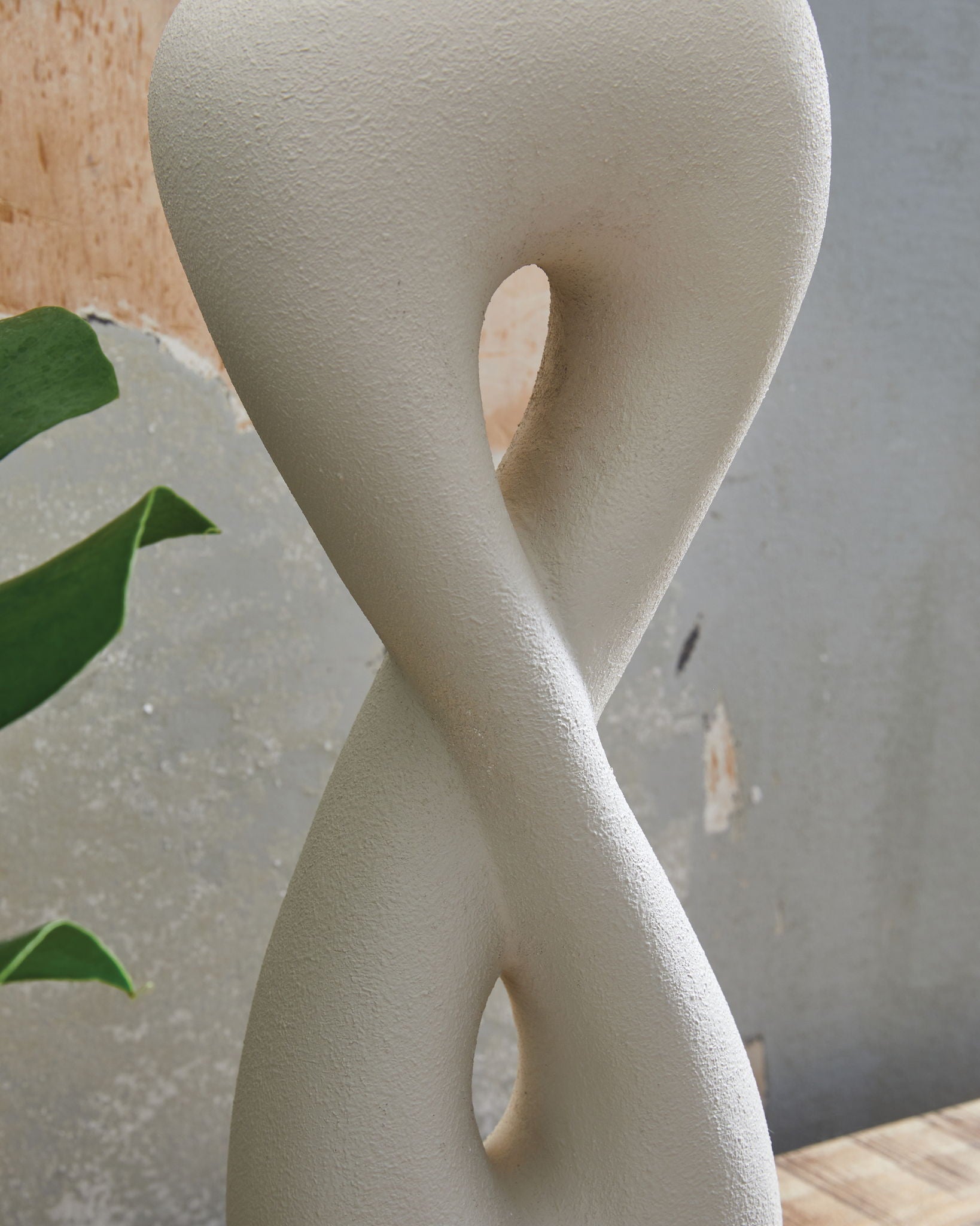 Sculpted white poly table lamp base with cutout hourglass shape and gold base ring