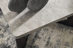 Gray square table top with beveled edge and dark X-style legs, close-up