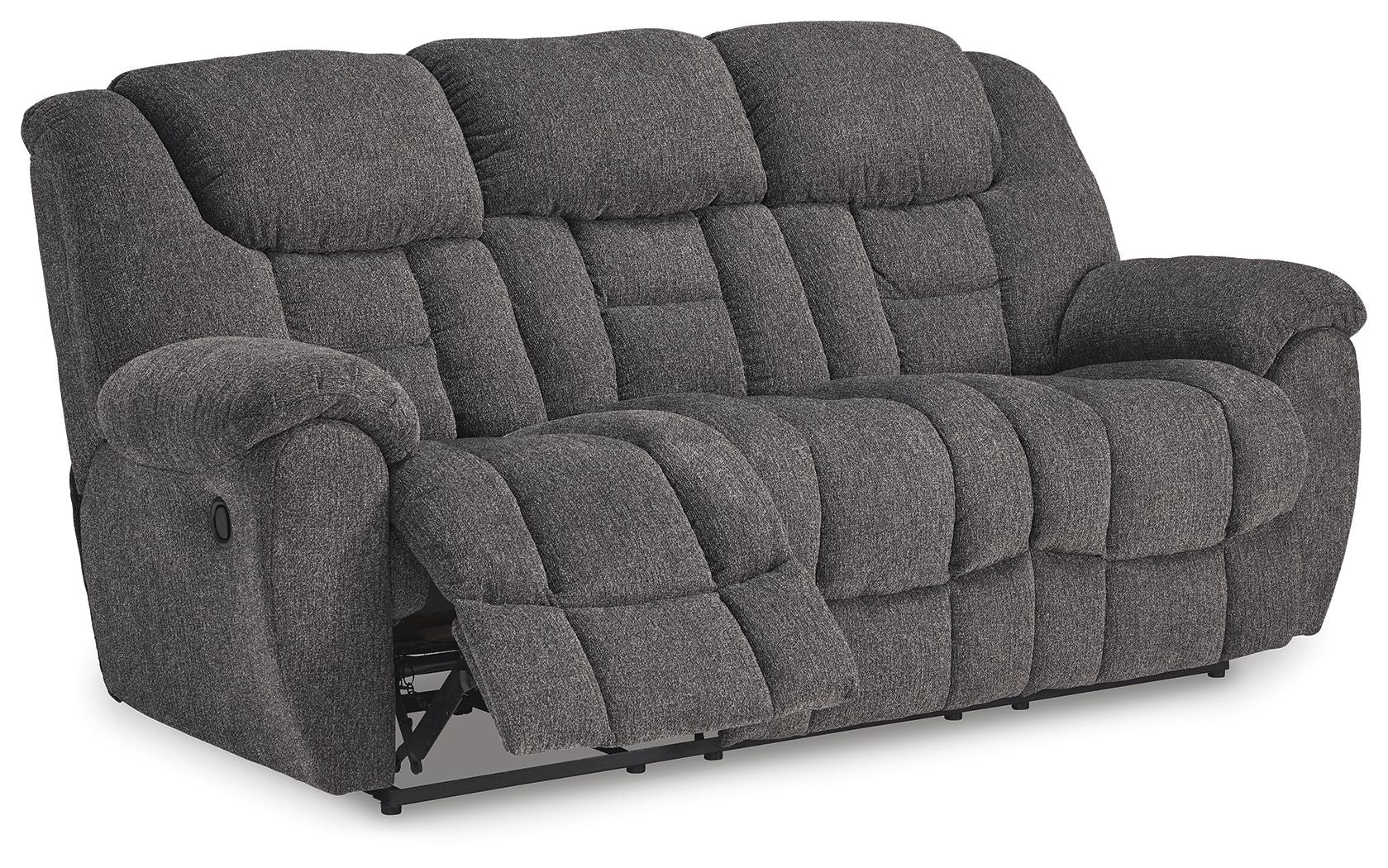 Dark gray reclining sofa with extended footrest, button-tufted cushions and arms