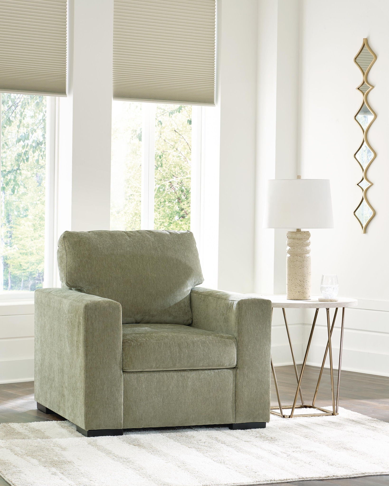 Moss green upholstered armchair with cushioned backrest and matching seat