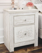 Whitewashed two-drawer night stand with carved drawer fronts and round knobs
