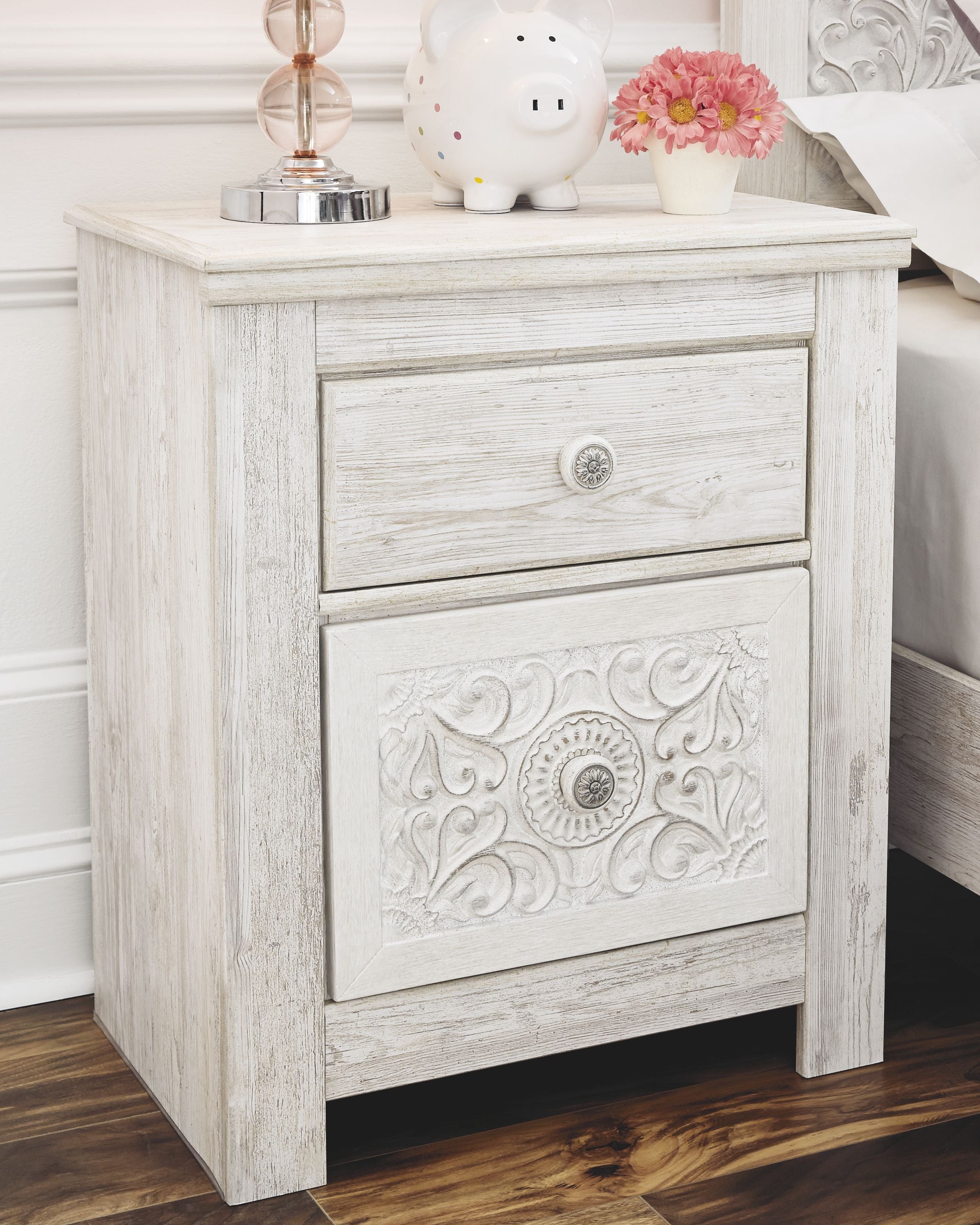 Whitewashed two-drawer night stand with carved drawer fronts and round knobs