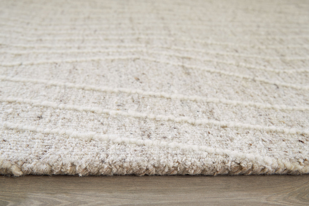 Cream rug edge with short textured pile visible along the border