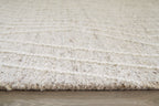 Cream rug edge with short textured pile visible along the border
