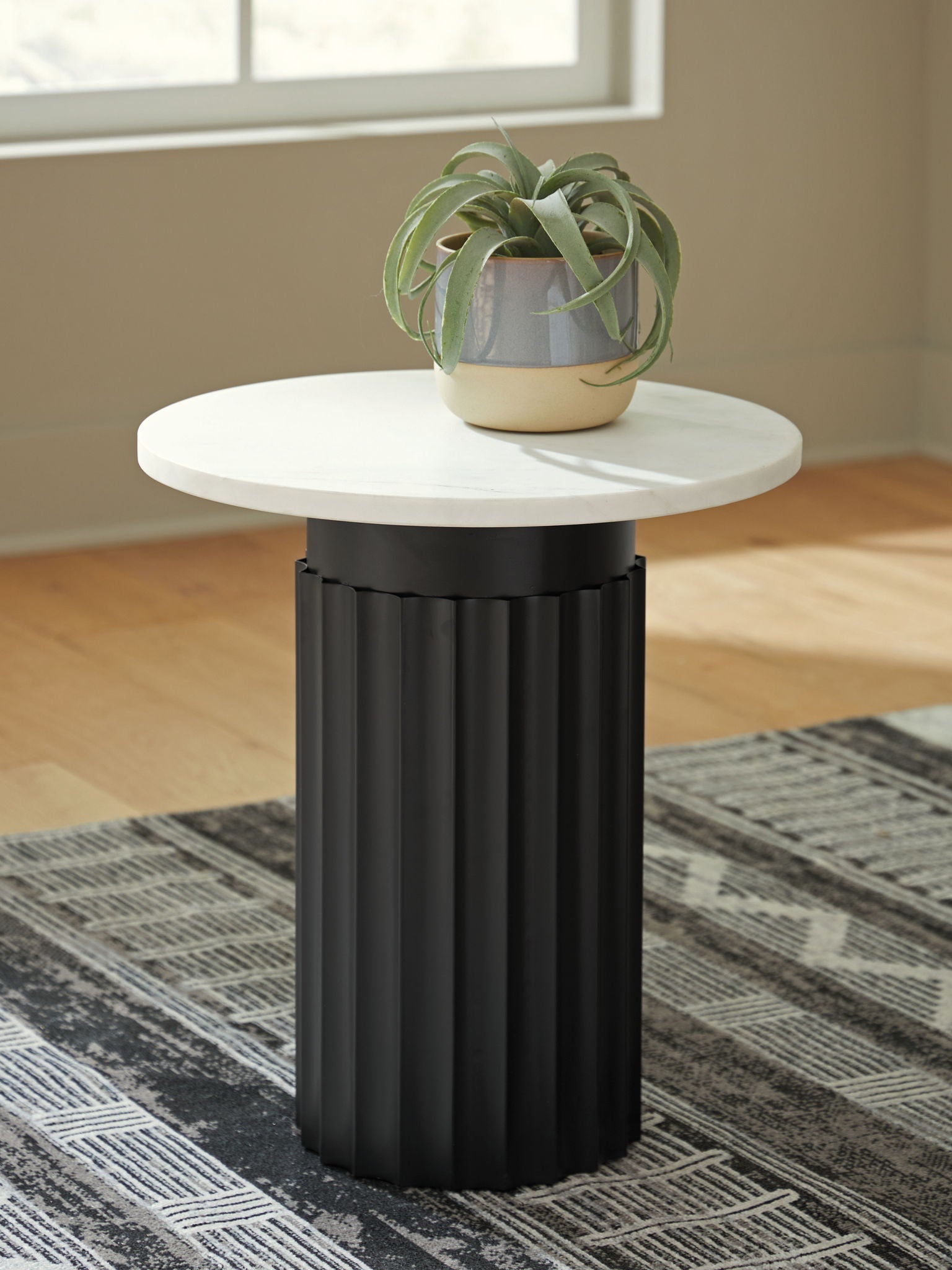 Accent table with round white top and black fluted column base