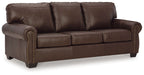 Dark brown upholstered loveseat with rolled arms and nailhead trim