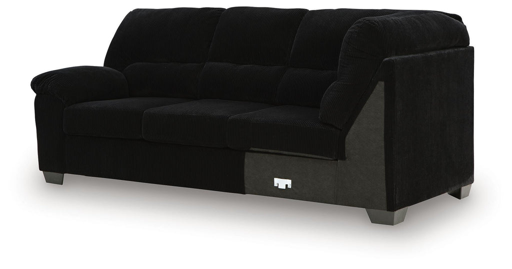 Black sofa with corner wedge, squared track arms, tufted seat and back