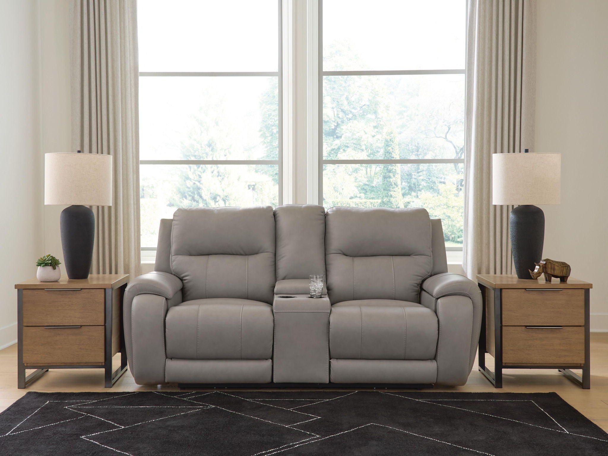 Gray power reclining loveseat with padded arms and recliner seats, front view