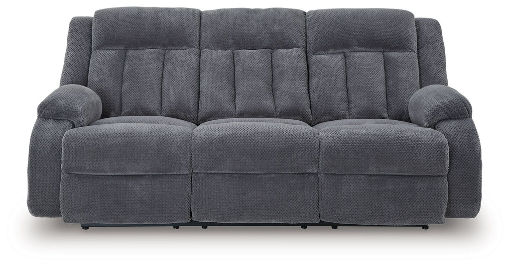 Reclining power sofa, dark gray tufted upholstery with two padded armrests
