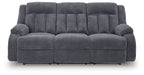 Reclining power sofa, dark gray tufted upholstery with two padded armrests