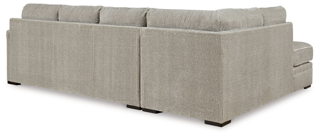 Beige fabric sectional sofa with square arms, back cushions, and low block legs