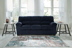 Navy corduroy sofa with three seat cushions and rolled armrests