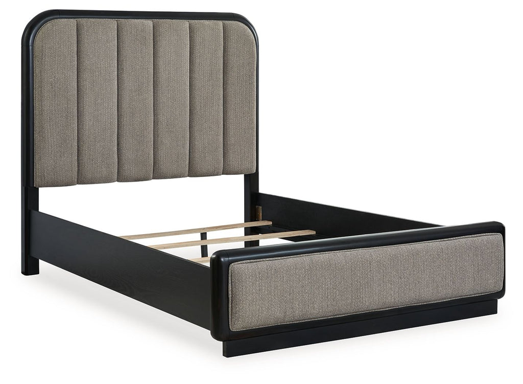 Dark gray upholstered panel bed with slatted support and black frame legs