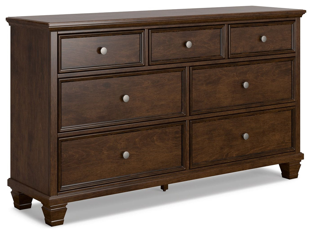 Brown dresser with several drawers and round metal knobs