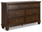 Brown dresser with several drawers and round metal knobs