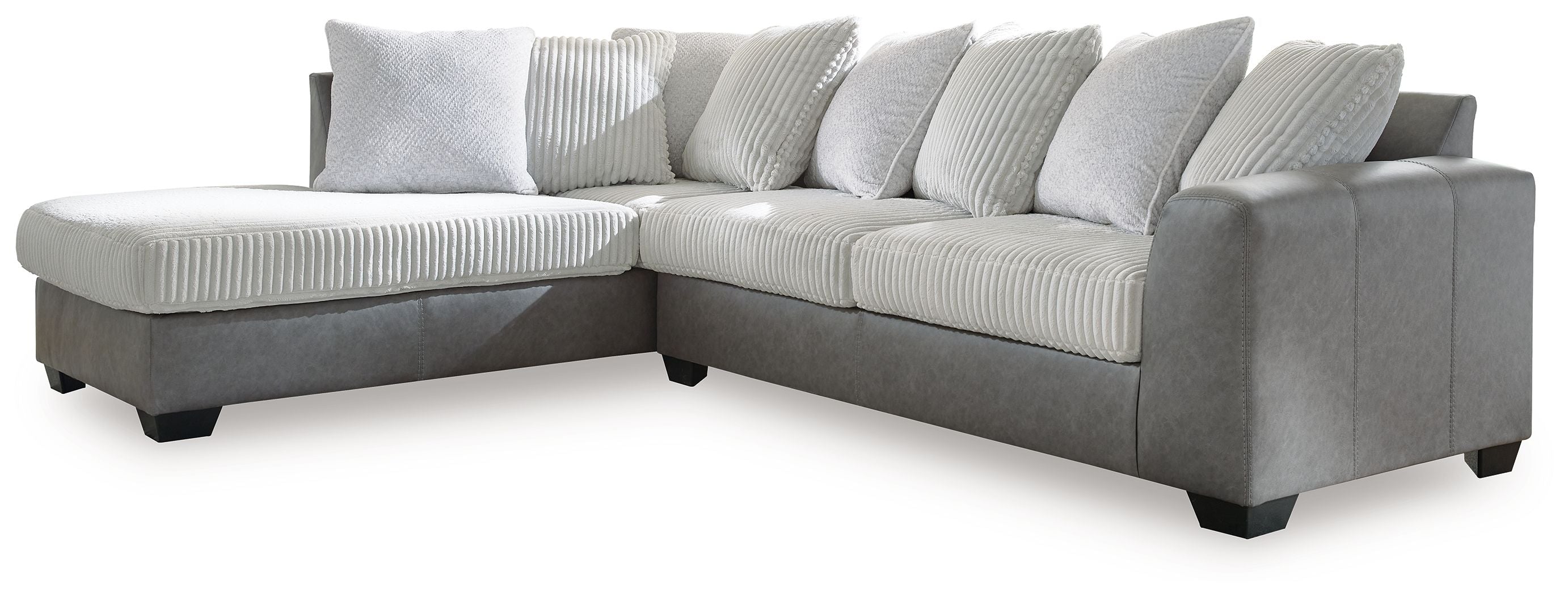 Light gray sectional sofa with chaise, striped throw pillows, and boxy armrests.