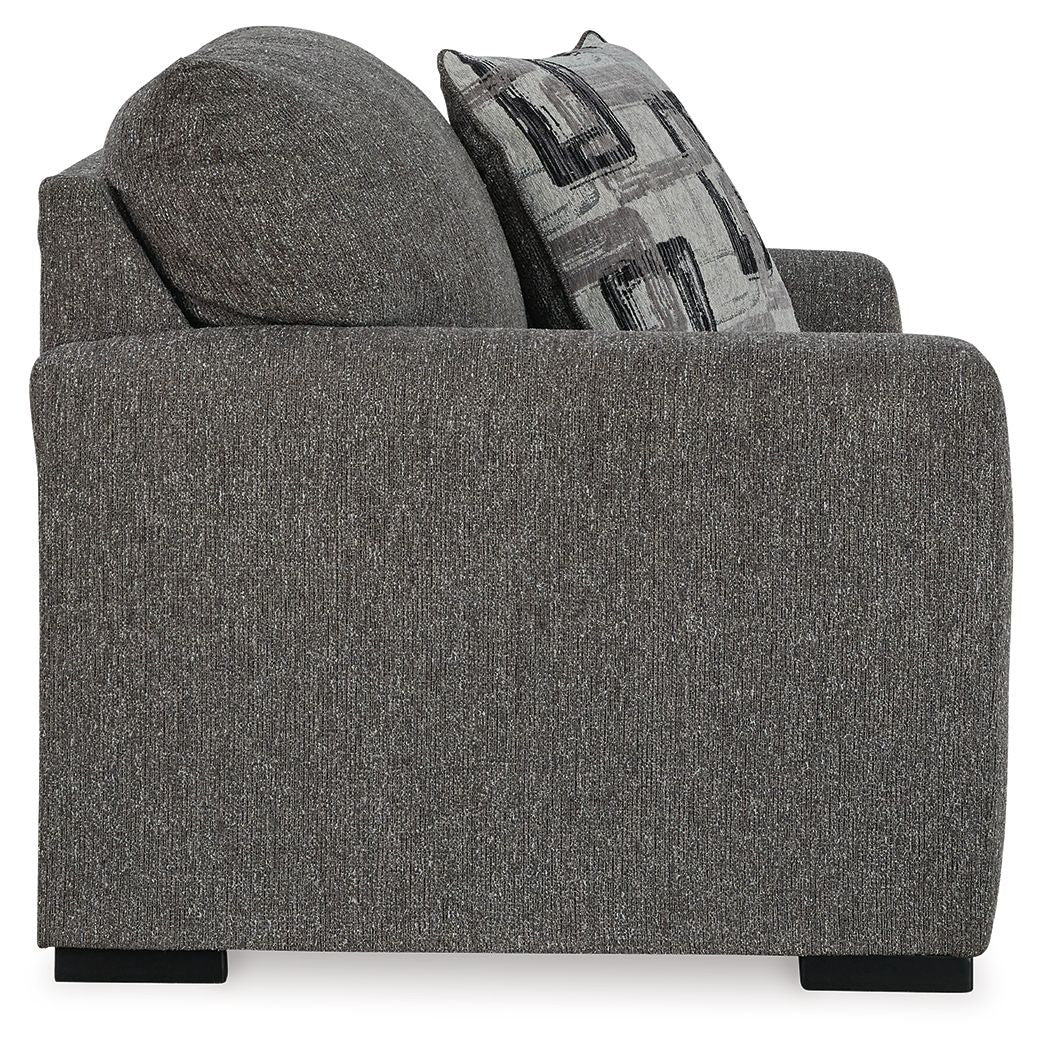 Pewter upholstered chair and a half with tall back and patterned throw pillow