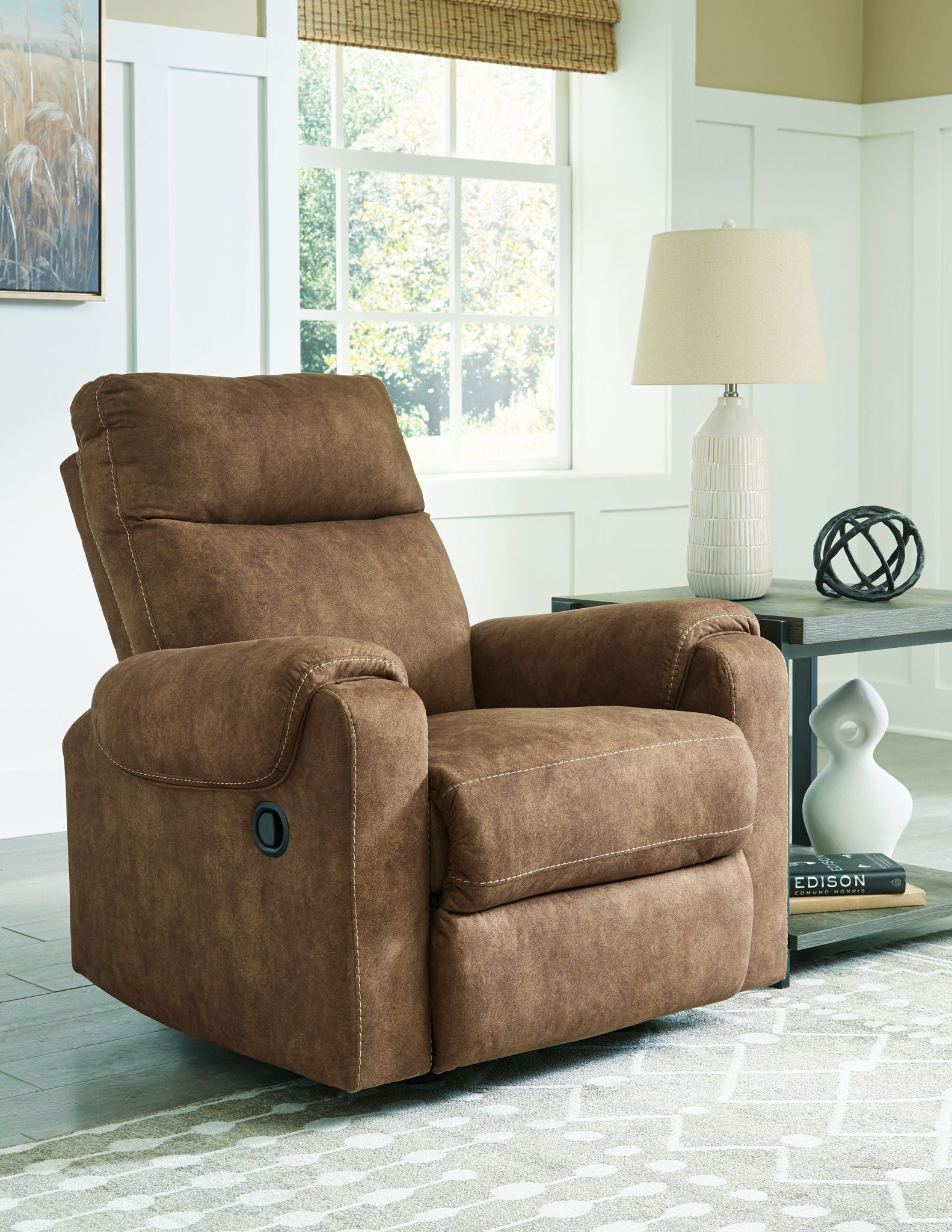 Brindle fabric rocker recliner with reclined seat and padded footrest