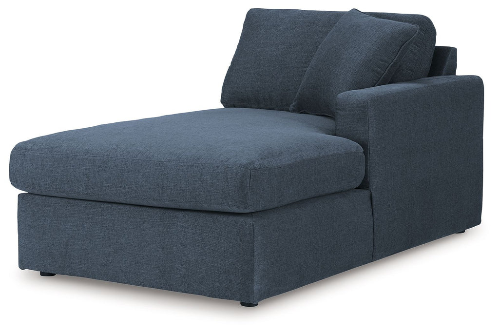 Dark blue upholstered corner chaise with wide armrest and two back cushions