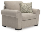 Chair and a half in heather light-gray fabric with patterned throw pillow