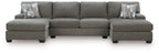 Gray sectional sofa with three-seat back and chaise arms, includes accent pillows