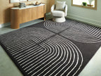 Eldonmore rug, black with white swirling contour lines, flat laid.
