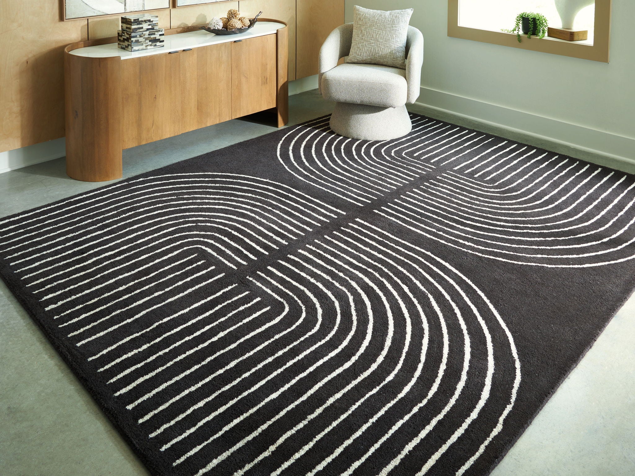 Eldonmore rug, black with white swirling contour lines, flat laid.