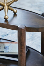 Gray-brown accent table corner with round top edge, turned support post, and lower shelf