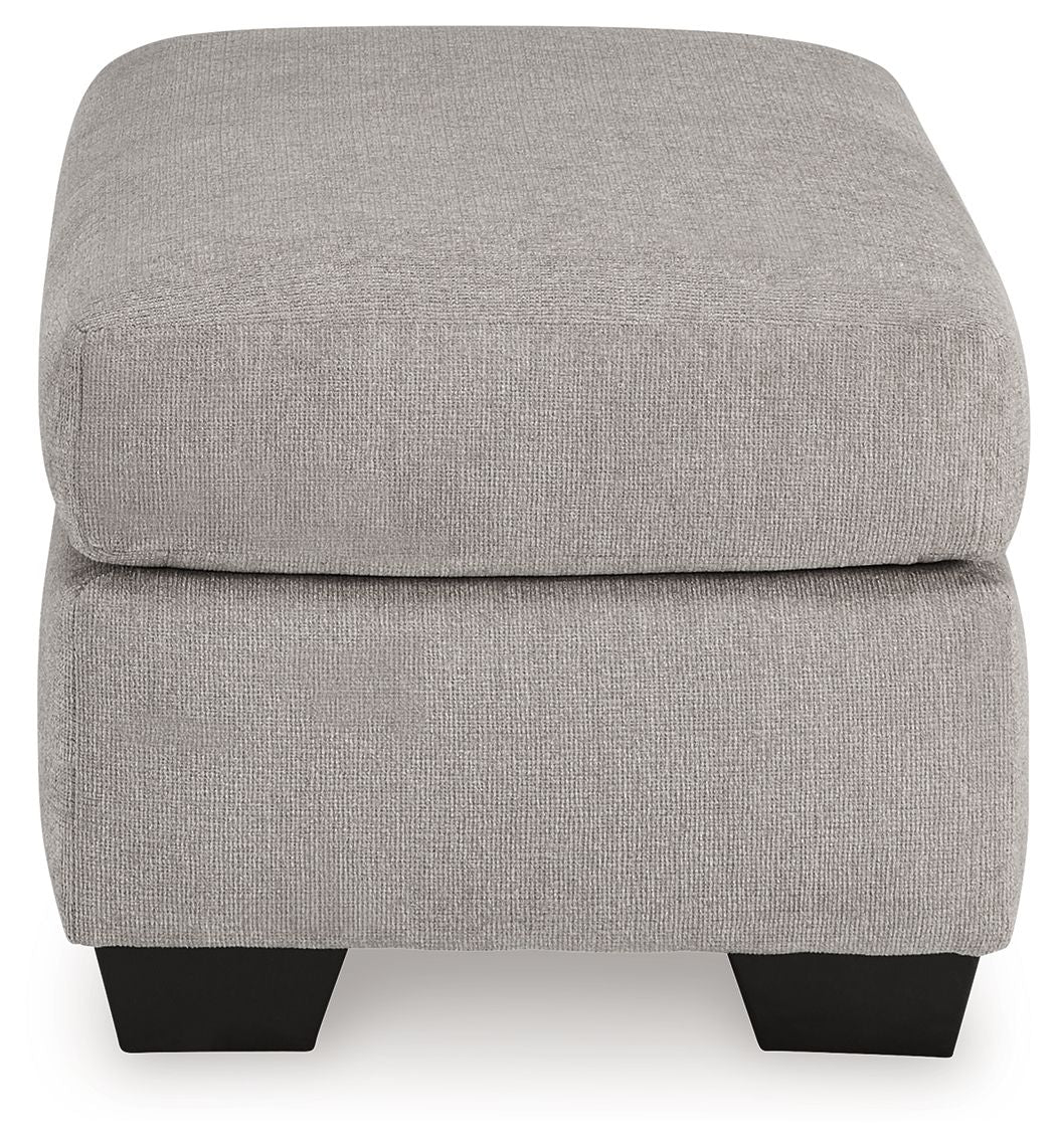 Light gray flannel ottoman, padded top and front panel with dark block legs