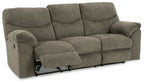 Reclining sofa in dark gray fabric with extended footrest and visible recline mechanism.