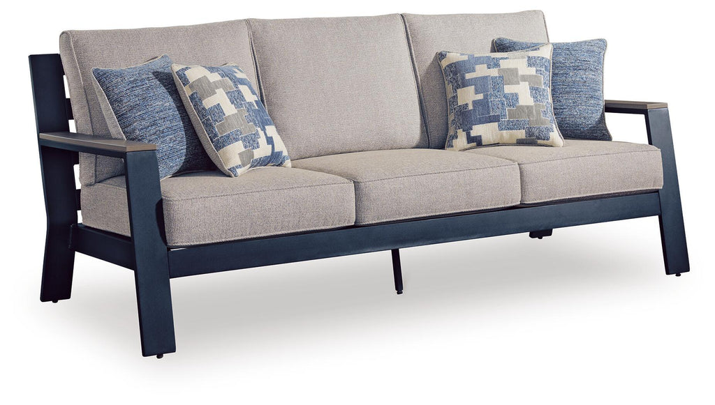 Gray sofa with blue patterned throw cushions and two upholstered seat cushions