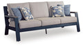 Gray sofa with blue patterned throw cushions and two upholstered seat cushions