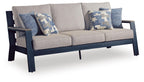 Gray sofa with blue patterned throw cushions and two upholstered seat cushions