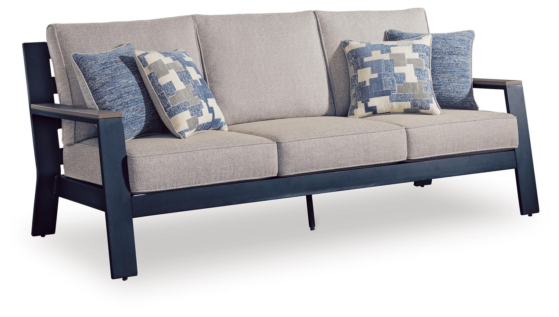 Gray sofa with blue patterned throw cushions and two upholstered seat cushions