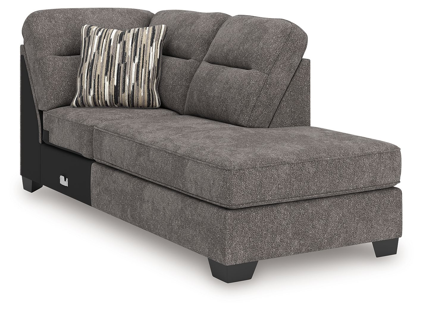 Corner chaise in dark gray fabric with rounded arm, tufted back, black legs; striped throw pillow.