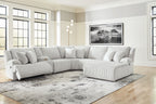 Light gray reclining sectional sofa with chaise seating and striped cushions