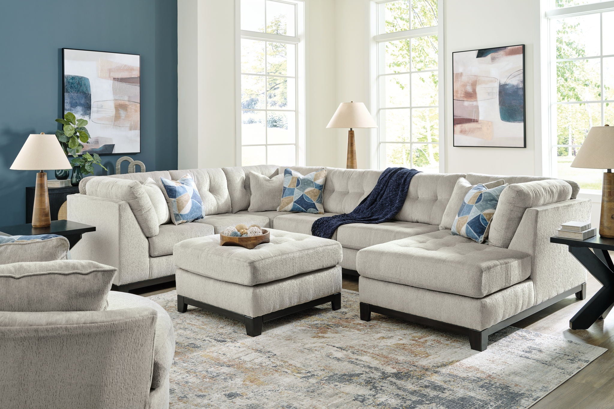 Beige corner sectional sofa set with ottoman and patterned throw pillows