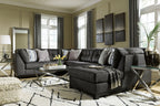 Gray sectional sofa corner chaise with textured upholstery and accent pillows
