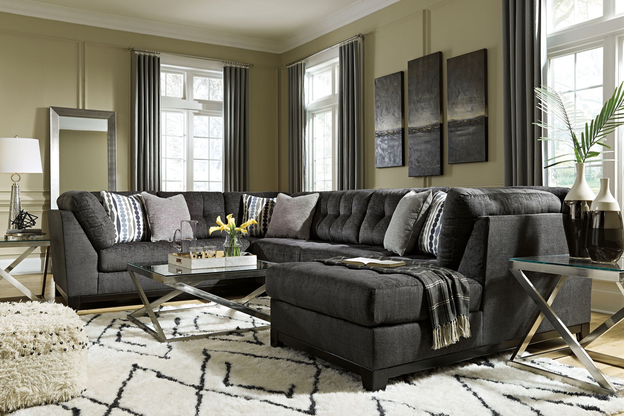 Gray sectional sofa corner chaise with textured upholstery and accent pillows