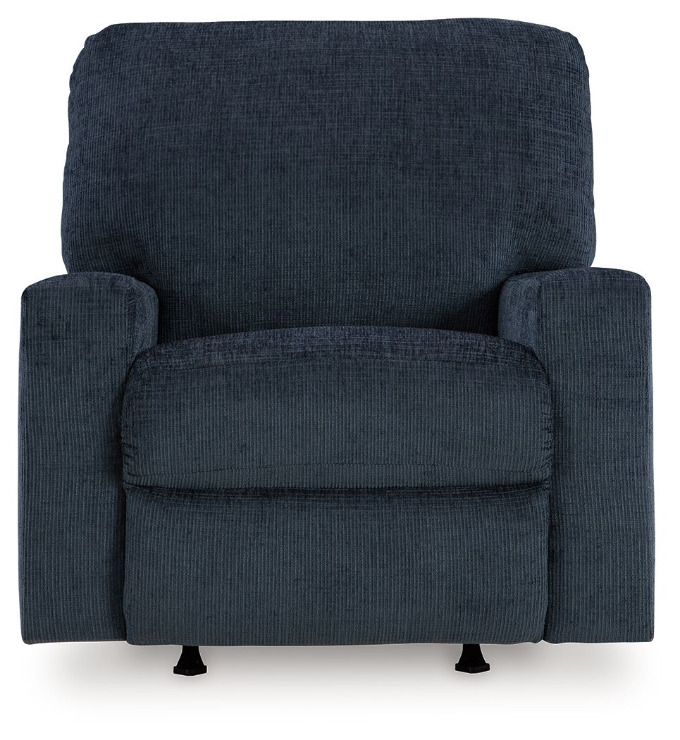 Rocker recliner chair in dark blue upholstered fabric with deep seat and side cushions.