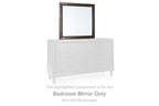 Bedroom mirror with merlot frame set atop white drawer dresser