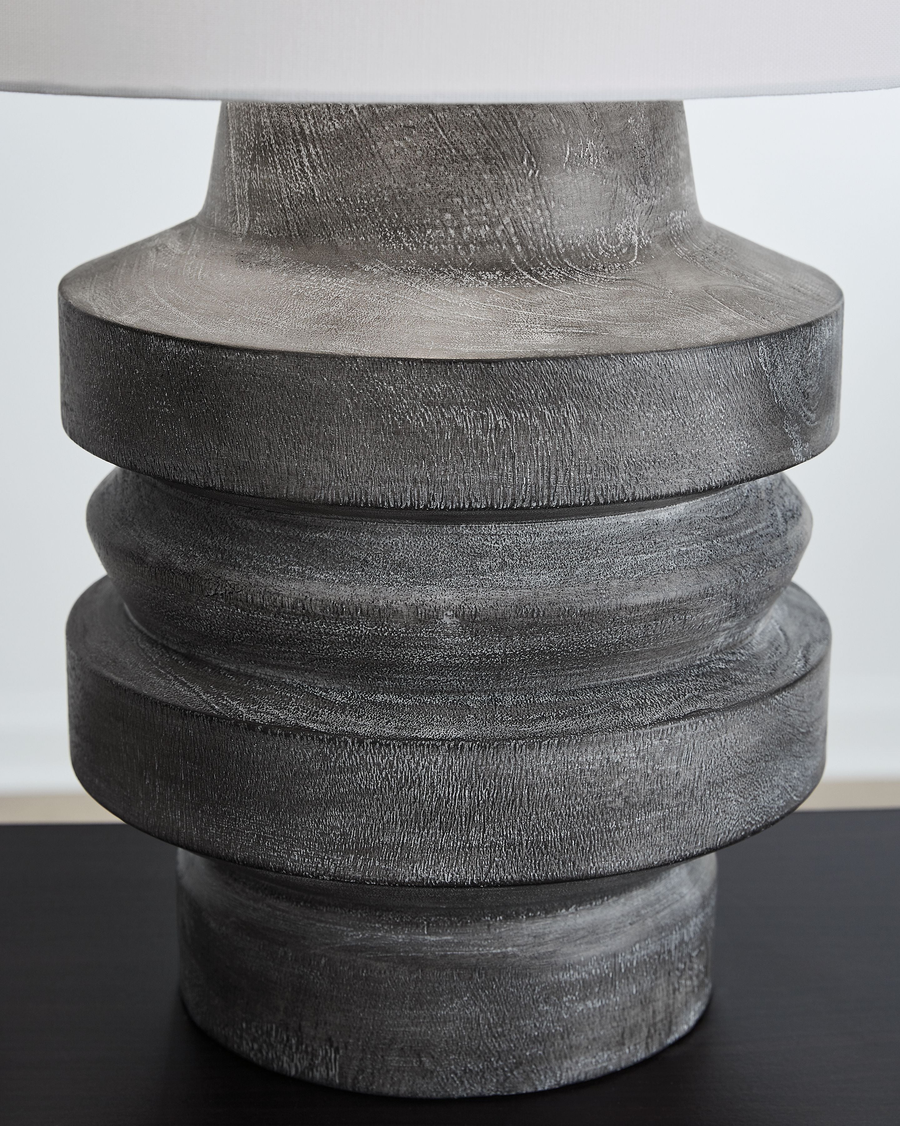 Distressed black poly table lamp base, stacked ridges and weathered finish