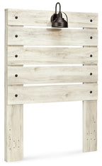 Beige panel headboard with horizontal plank panels and centered black lamp